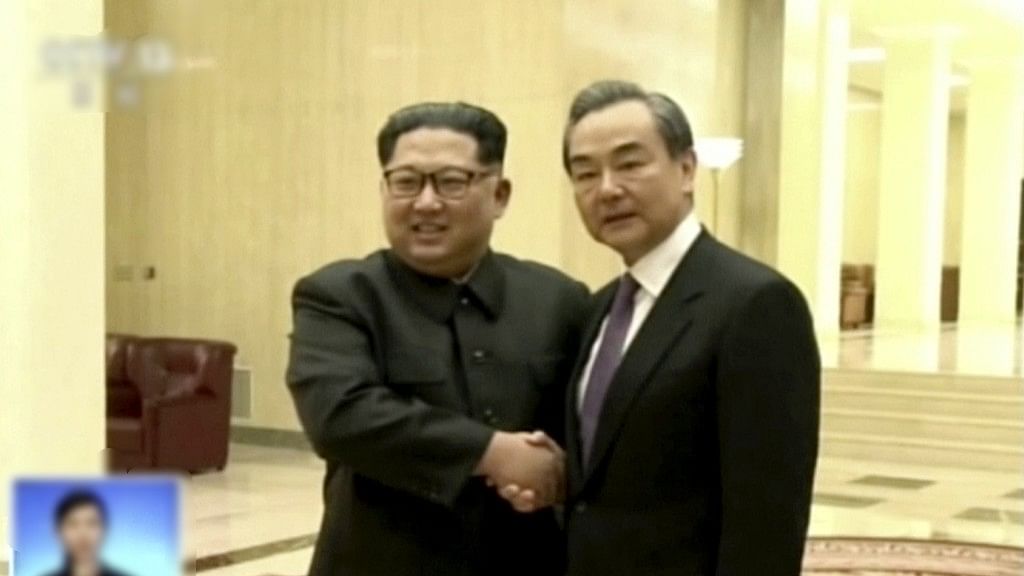 In this image, taken from video footage by China’s CCTV via AP Video, Chinese Foreign Minister Wang Yi (right) meets North Korean leader Kim Jong Un in Pyongyang.