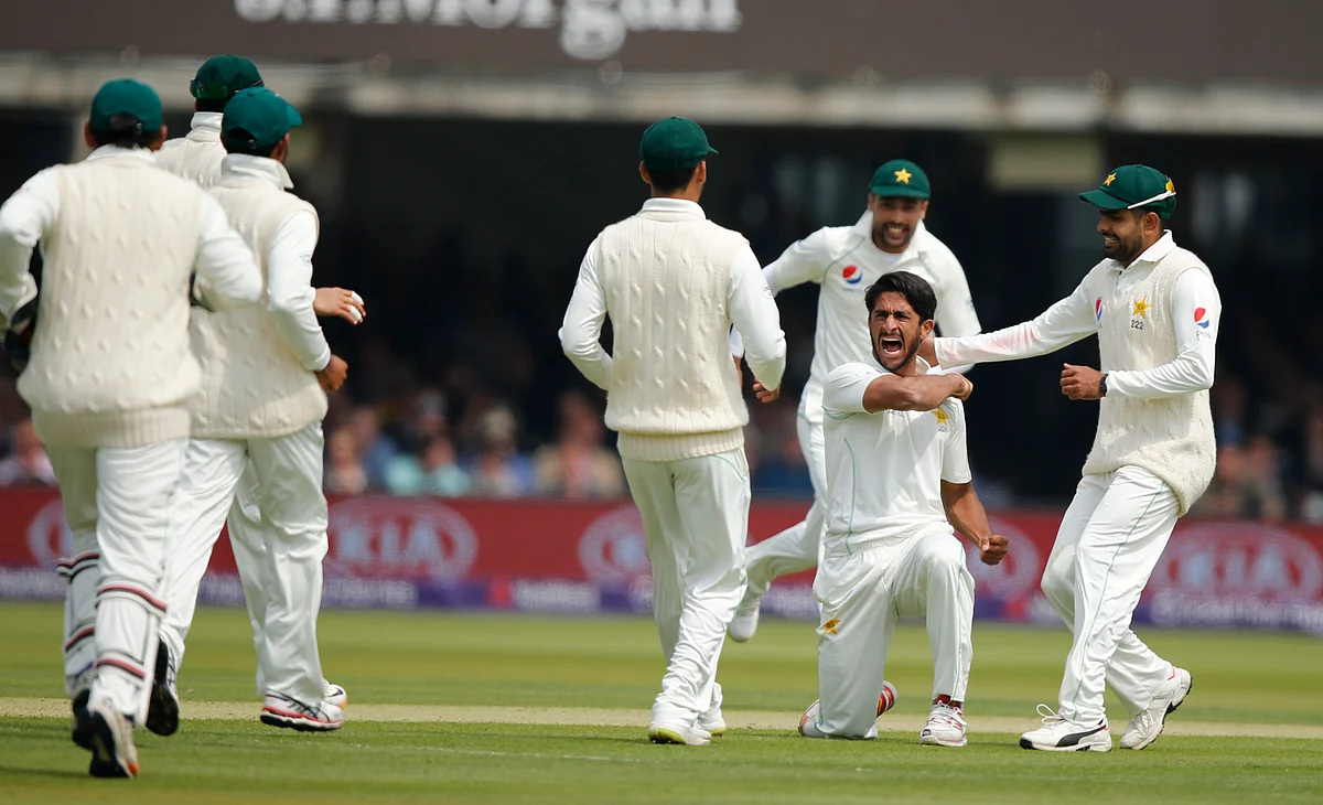 Pakistan’s Hasan Ali, celebrates with teammates after taking the wicket of England’s Joe Root, caught behind, during the first day of play of the first test cricket match between England and Pakistan.
