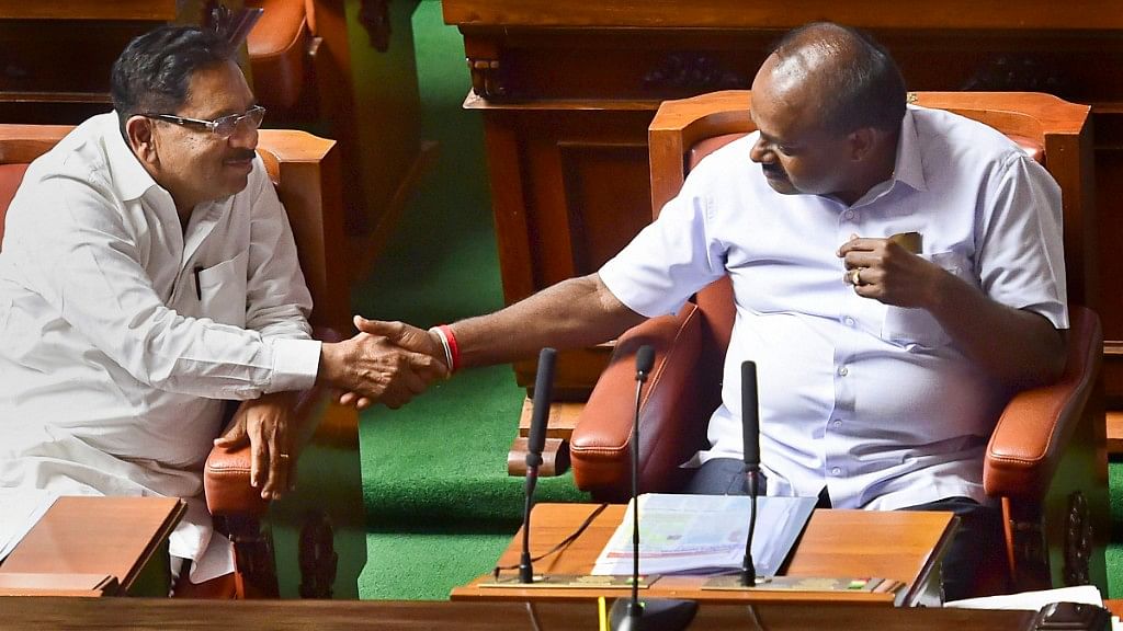 Karnataka Chief Minister HD Kumaraswamy and his deputy G Parameshwara greet each other after their coalition government won the trust vote.