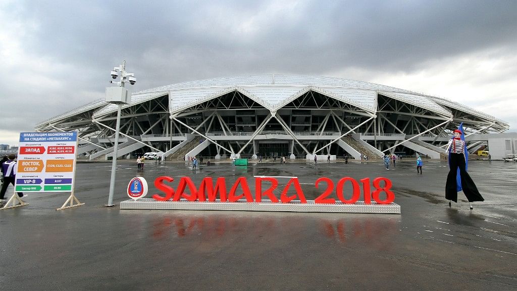 An artist performs, waiting for football fans at the new the World Cup stadium in Samara