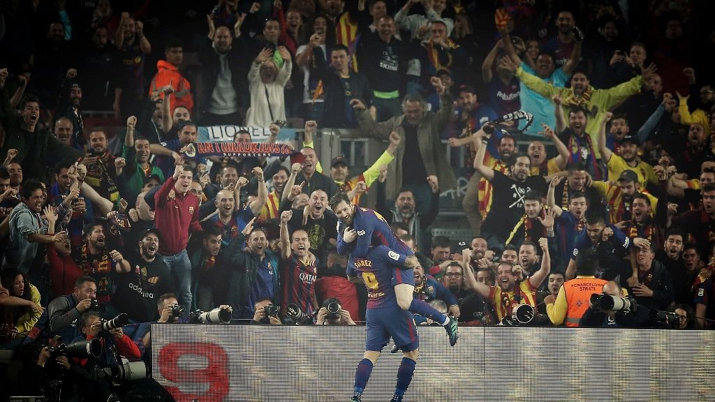 Football fans in Spain take the sport to the next level. Seen here, Lionel Messi celebrating a goal for Barcelona with Luis Suarez.