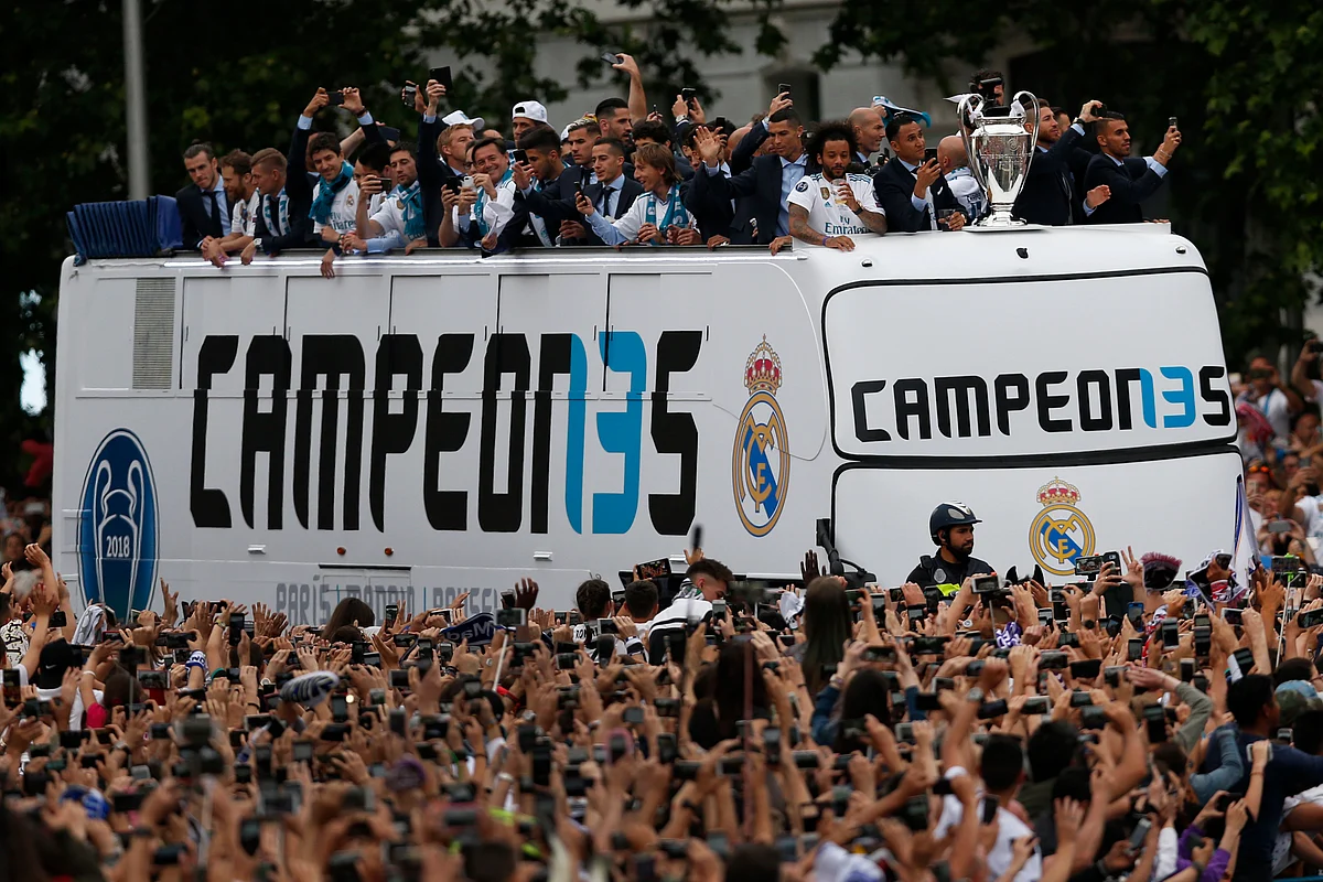 Real Madrid players wave to fans from the top of an open top bus in Cibeles square in Madrid.