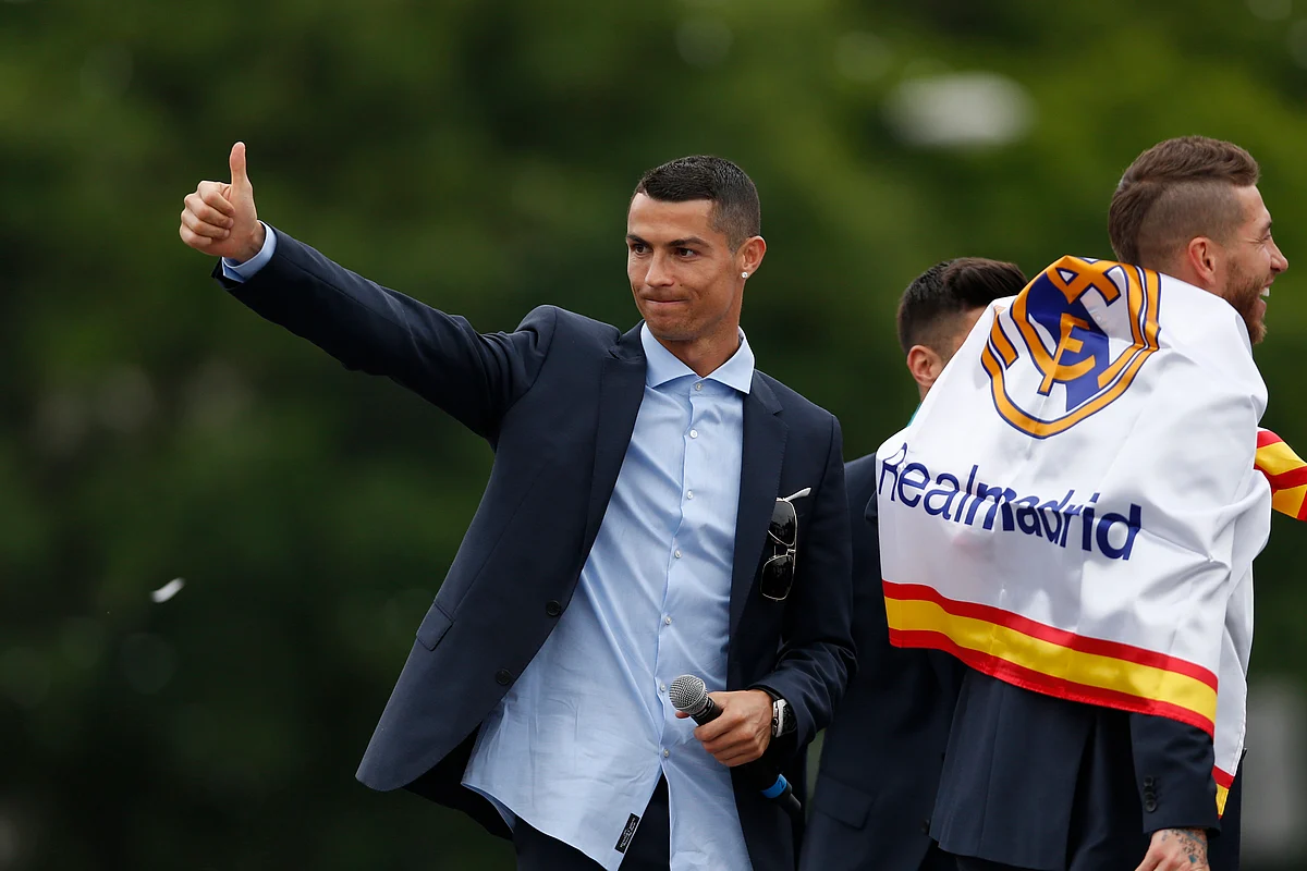 Real Madrid’s Cristiano Ronaldo gestures to supporters as he celebrates with teammates at the Cibeles square in Madrid.