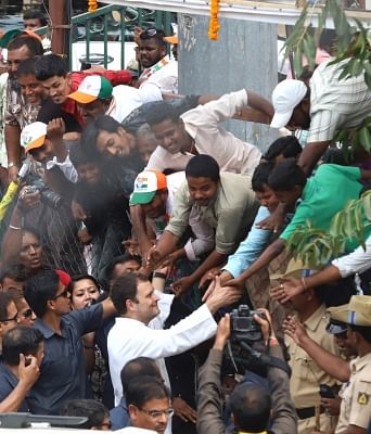 Bengaluru: Congress President Rahul Gandhi interacts with people during a party rally ahead of Karnataka assembly polls at Russell Market in Bengaluru on May 9, 2018. (Photo: IANS)