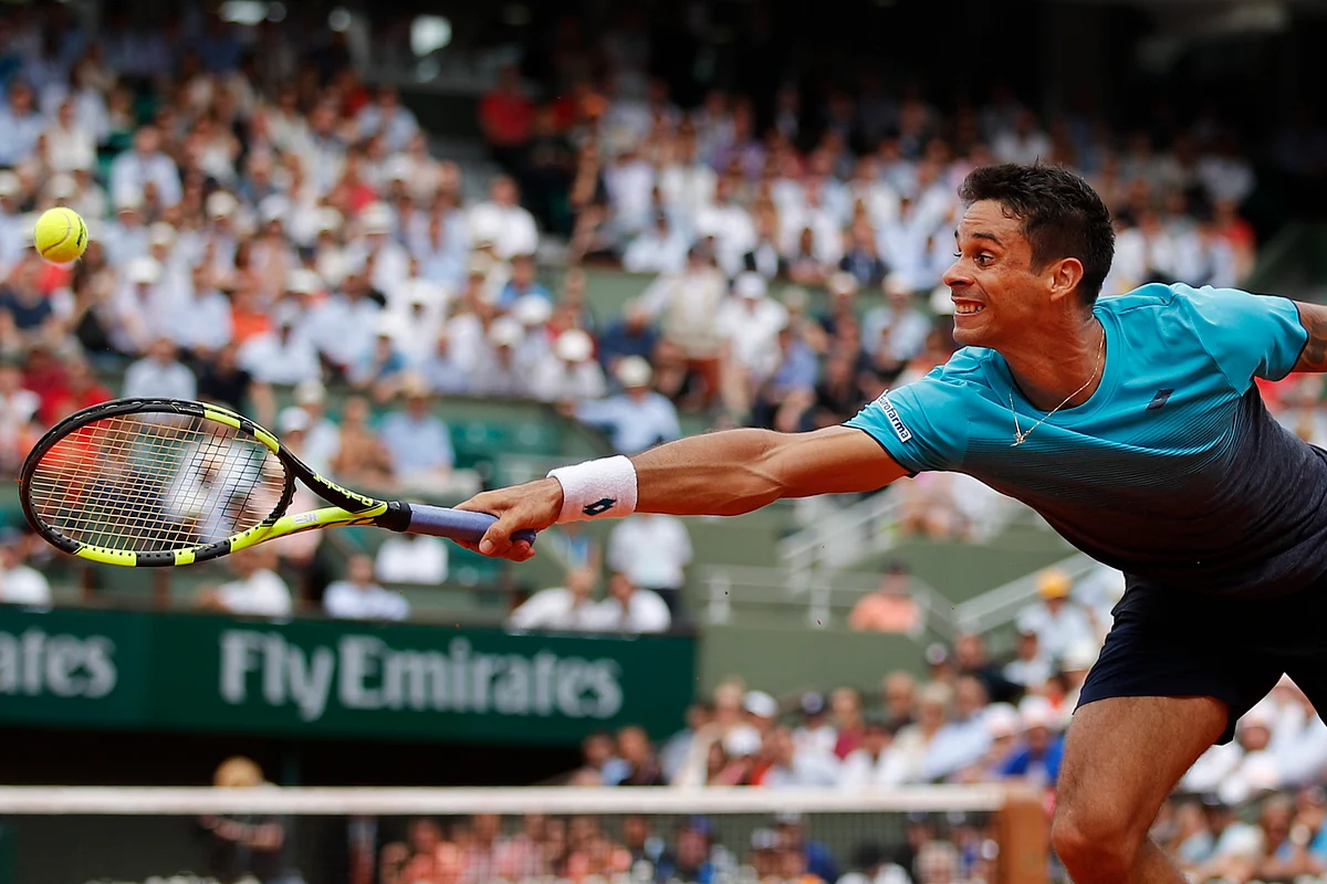Brazil’s Rogerio Dutra Silva dives to return a shot against Serbia’s Novak Djokovic during their first round match of the French Open tennis tournament at the Roland Garros stadium in Paris, France, Monday, May 28, 2018.