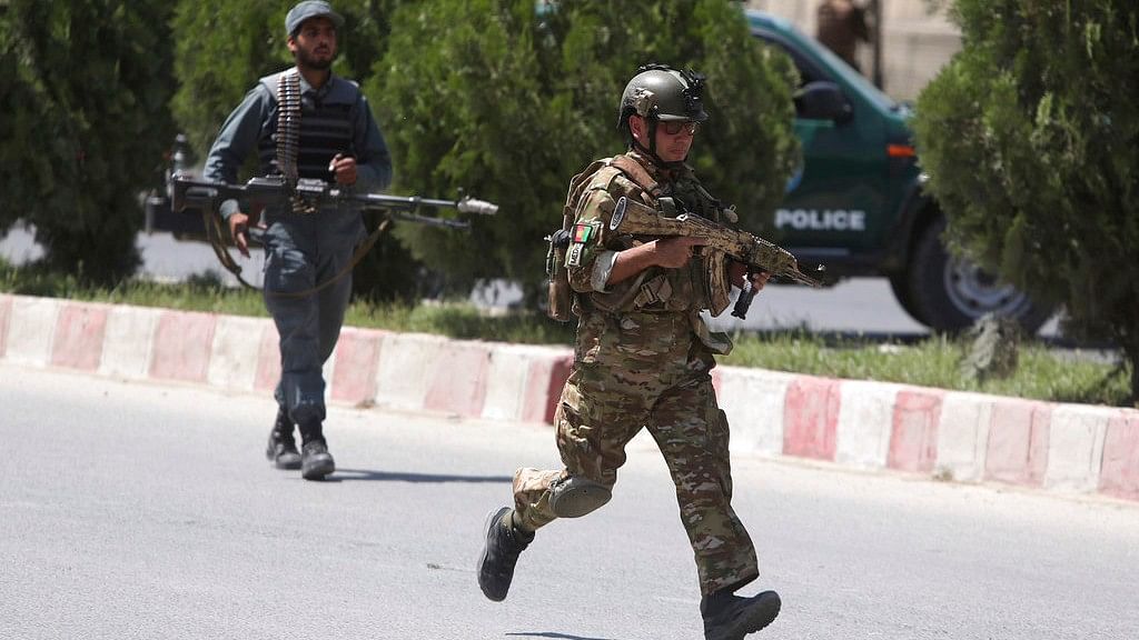 Security personnel arrive at the site of an attack in the Afghan Interior Ministry in Kabul, Afghanistan on 30 May.