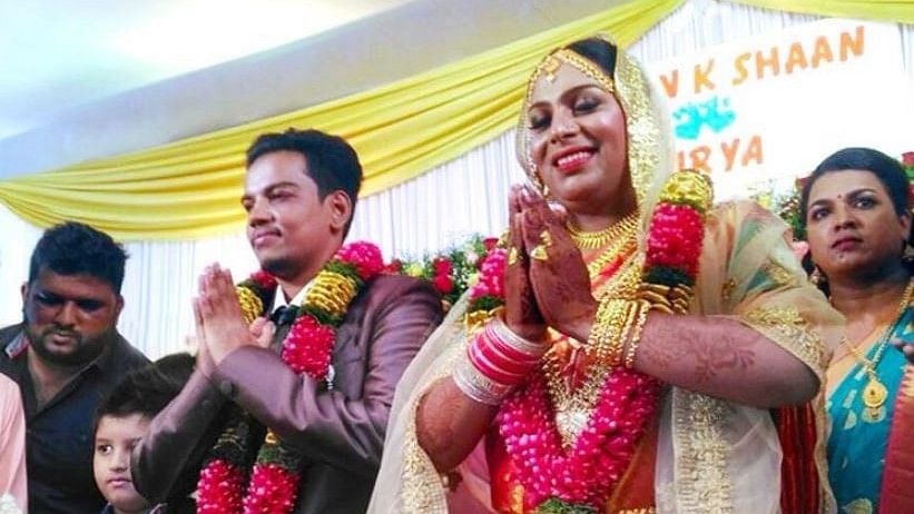 Ishan and Surya greeting guests at their wedding.