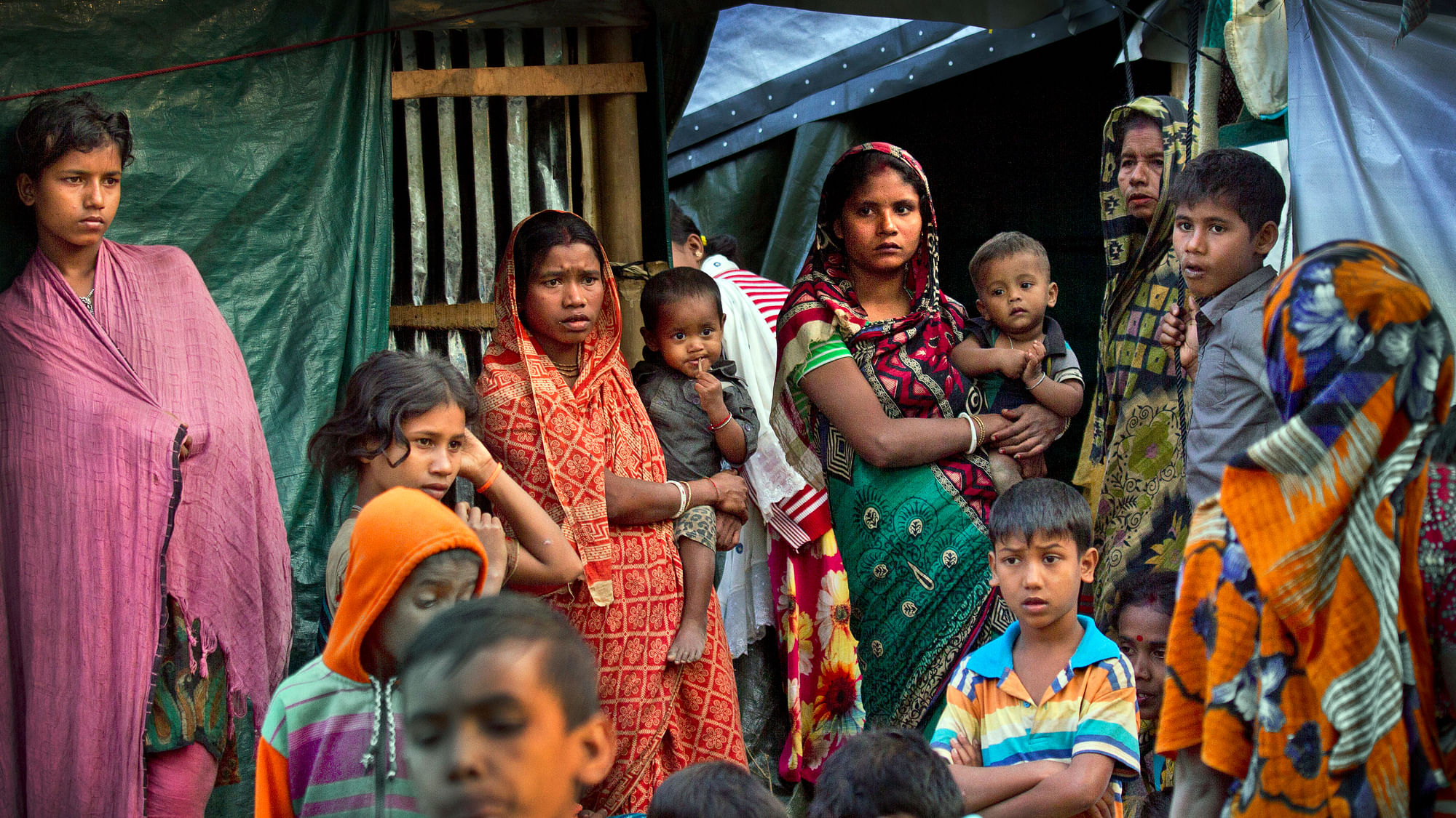 In this 16 January 2018, file photo, Hindu refugees stand outside their makeshift shelters at Kutupalong refugee camp near Cox’s bazar, Bangladesh.