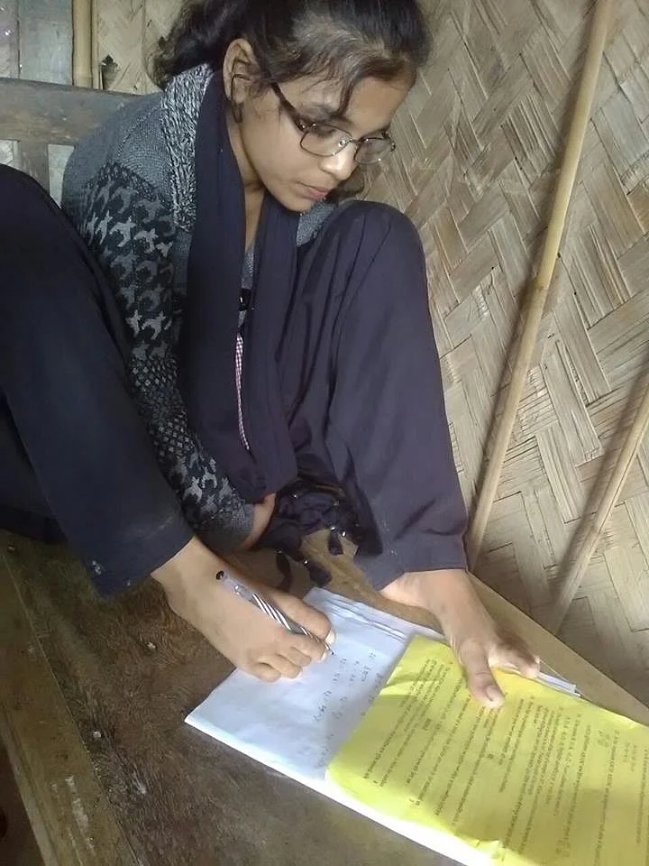 The school has printed Kousar’s picture on the back of all the student identity cards, which show her appearing for the exam, holding the pen firmly with her feet.