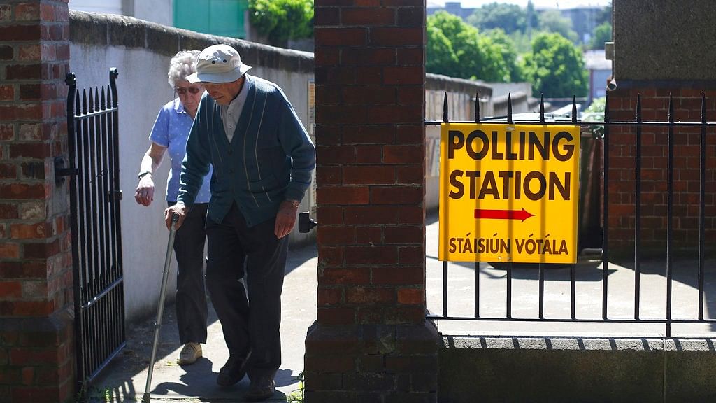 A couple leave a polling station after voting in the referendum on the 8th Amendment of the Irish Constitution, in Knock, Ireland, Friday, 25 May 2018.