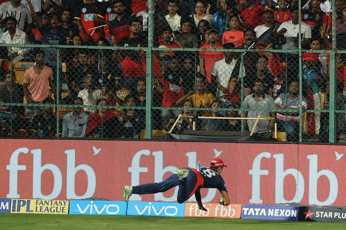 Trent Boult stops his momentum at the boundary rope. 
