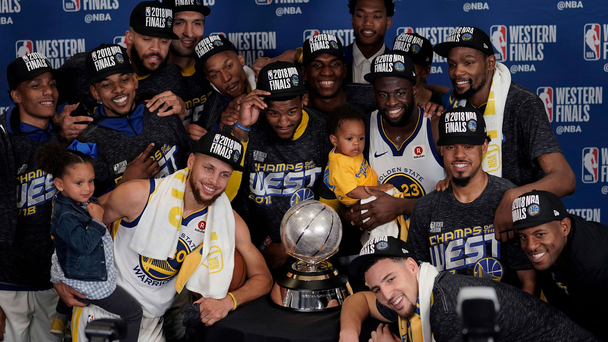 The Golden State Warriors pose with their trophy after defeating the Houston Rockets in Game 7 of the NBA basketball Western Conference finals, Monday, May 28, 2018.