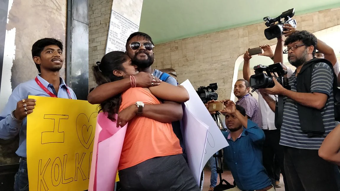 A couple hugs in public to protest Tuesday’s incident where a mob allegedly attacked a boy and a girl for hugging.