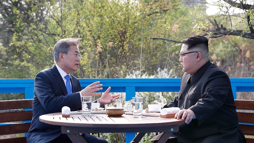 In this 27 April, 2018 photo, North Korean leader Kim Jong Un, right, and South Korean President Moon Jae-in, left, talk at a footbridge at the border village of Panmunjom in the Demilitarized Zone, South Korea.