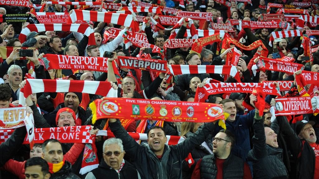 Liverpool fans sing “You’ll Never Walk Alone” as they hold up scarves prior to the Champions League semi-final.