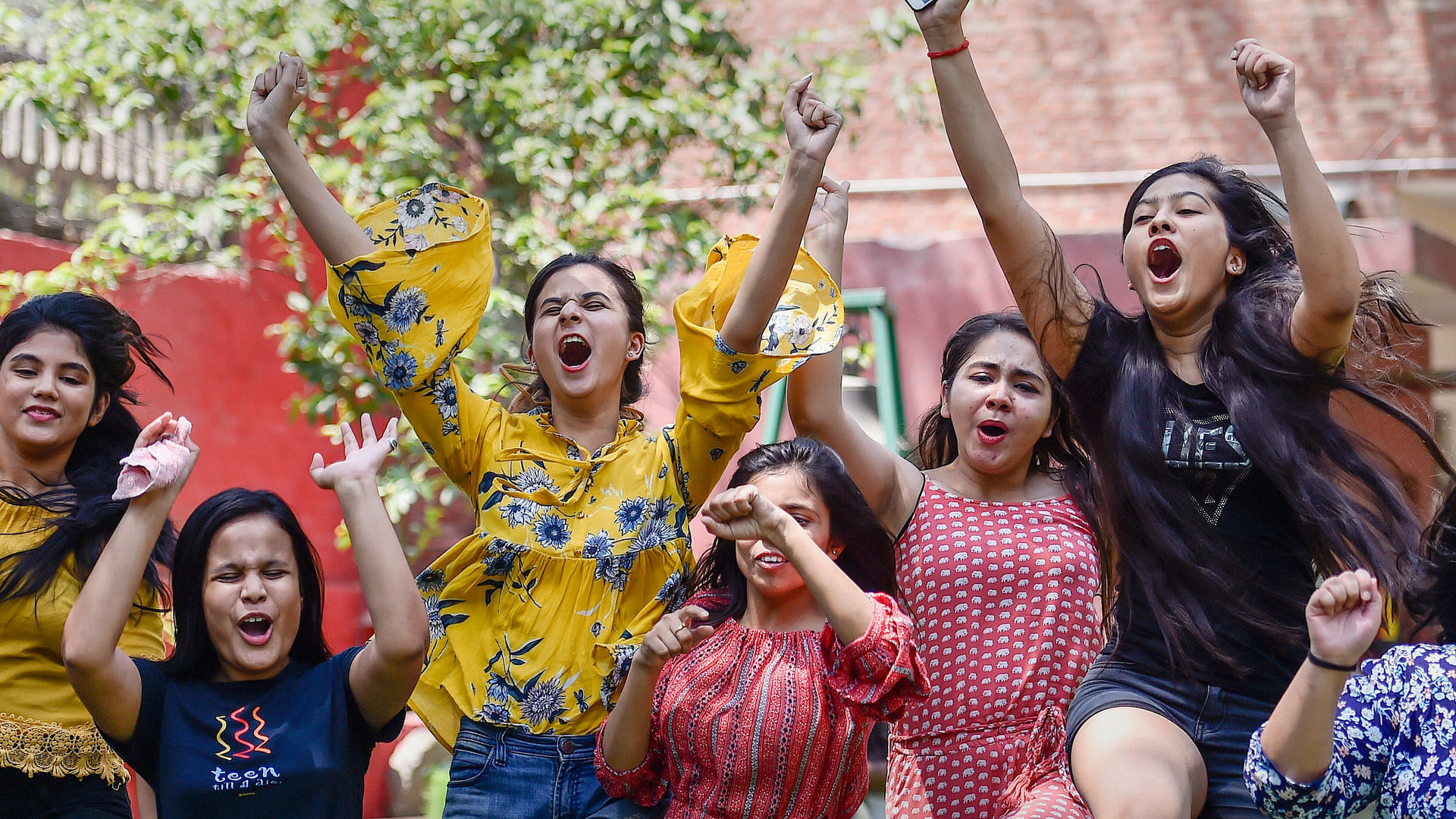 Students celebrate after the results are declared.