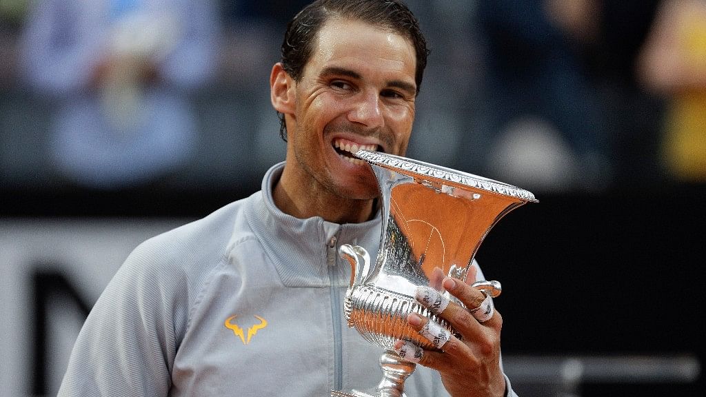 Rafael Nadal bites the trophy after beating Germany’s Alexander Zverev in the final match of the Italian Open tennis tournament in Rome on Sunday.