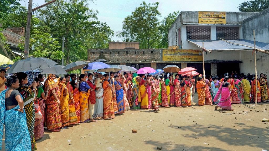 Women stand in a queue to cast their vote for panchayat election at Shantipur polling station in Nadia district of West Bengal on Monday, 14 May.&nbsp;