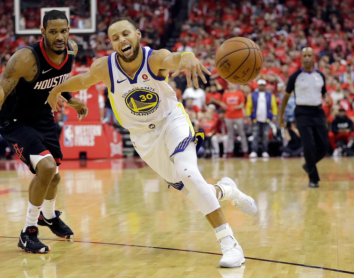 Golden State Warriors guard Stephen Curry (30) lose control of the ball as he drives around Houston Rockets forward Trevor Ariza (1) during the first half in Game 7 of the NBA basketball Western Conference finals, Monday, May 28, 2018, in Houston. 