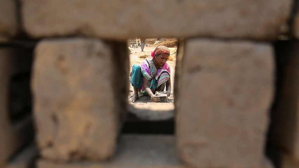An Indian labourer works at a brick factory on the outskirts of Jammu, India, Tuesday, 1 May 2018.