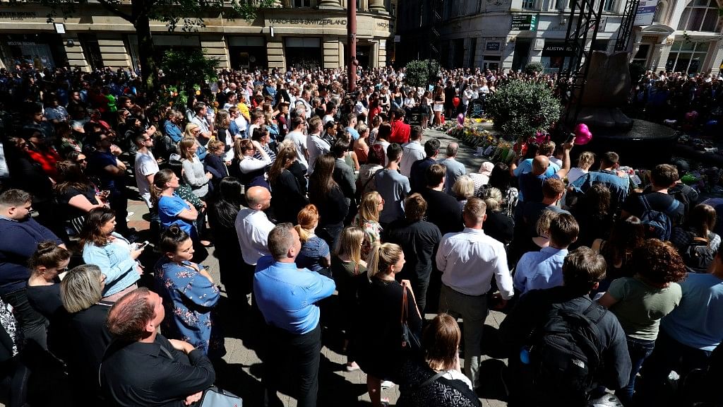 Members of the public observe a minutes silence as they gather in St Ann’s Square to mark one year since the terror attack on Manchester Arena.