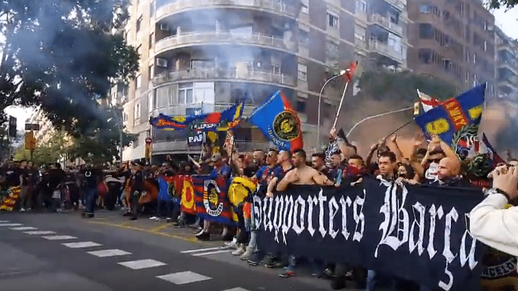 Barcelona supporters march towards Camp Nou ahead of the El Clasico on Sunday.