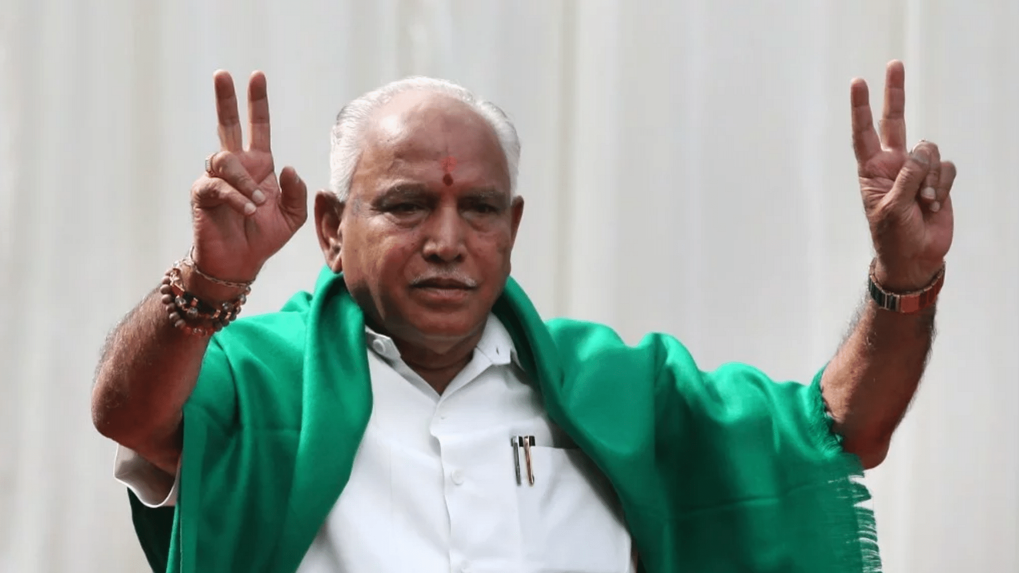 BJP’s BS Yeddyurappa flashes victory sign after he was sworn in as chief minister of Karnataka in Bangalore.