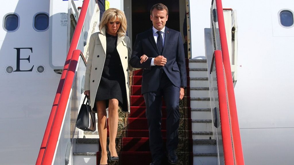 French President Emmanuel Macron and his wife Brigitte Macron exit the plane upon their arrival in St Petersburg, Russia.