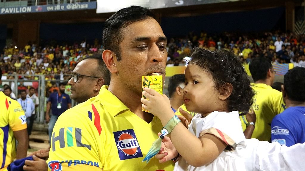 Ziva and dad MS Dhoni share a celebratory drink after CSK lifted the IPL 2018 trophy.