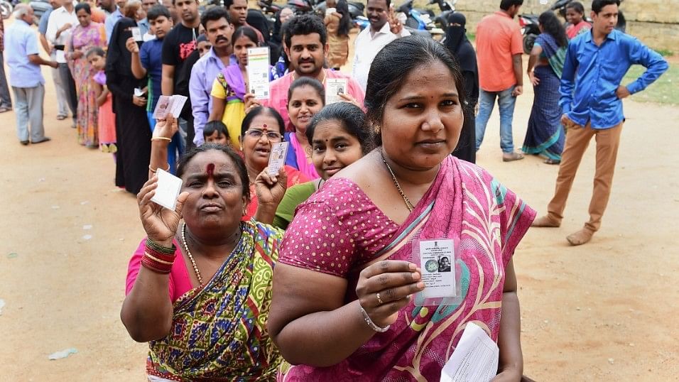 People queued up to cast their ballot during the polling day for the Karnataka.