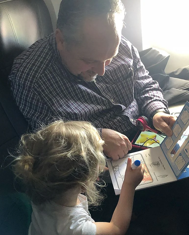 Caroline and Todd on a colouring spree on the plane