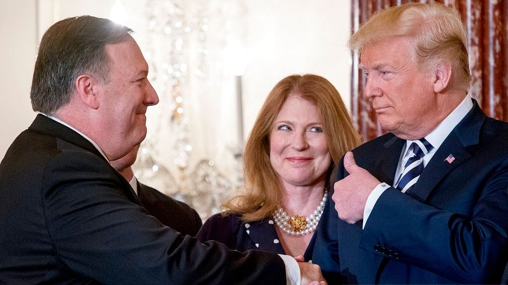  Secretary of State Mike Pompeo, accompanied by his wife Susan, gets a thumbs up from President Donald Trump, after being ceremonially sworn in at the State Department.