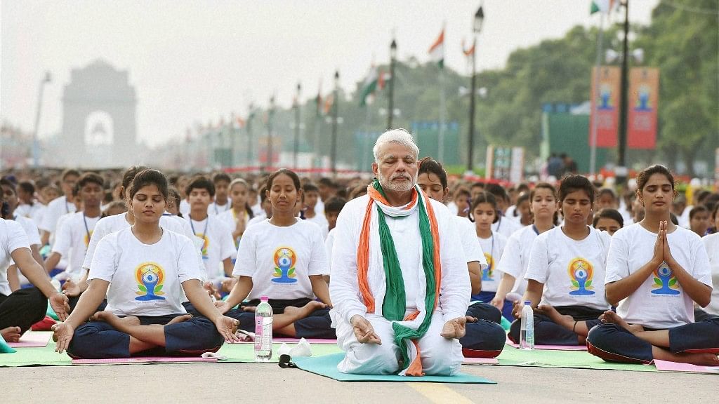  Prime Minister Narendra Modi performs yoga along with other participants during a mass yoga session on the International Day of Yoga 2015 at Rajpath in New Delhi.&nbsp;