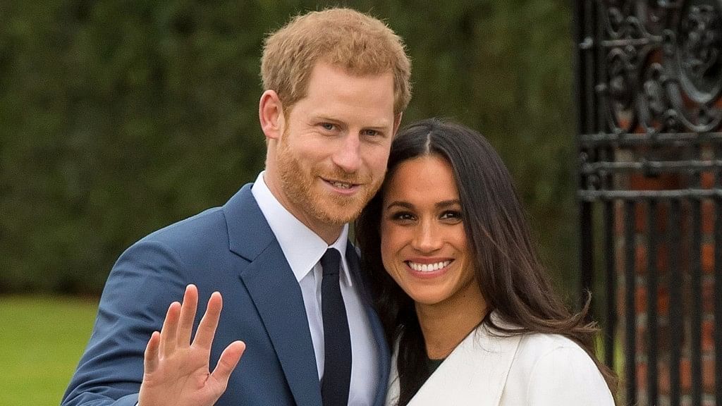 Britain’s Prince Harry and his fiancee Meghan Markle pose for photographers