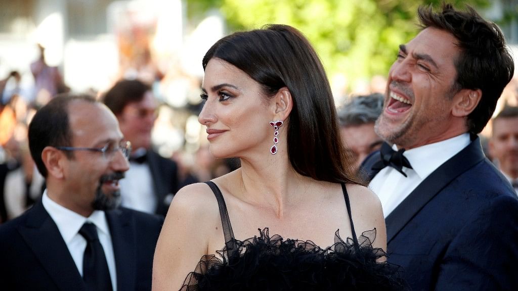Actor Penelope Cruz looks on as Javier Bardem has a hearty laugh at the opening ceremony and screening of the film <i>Everybody Knows</i> at the 71st Cannes Film Festival.