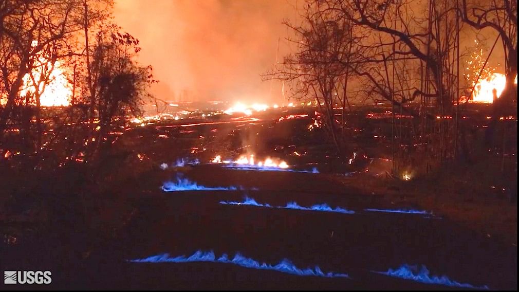 This photo from video from the US Geological Survey shows blue burning flames of methane gas erupting through cracks on Kahukai Street in the Leilani Estates neighborhood of Pahoa on the island of Hawaii.&nbsp;