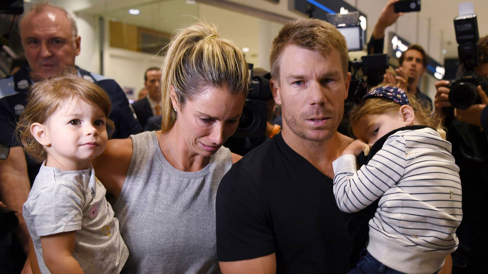 David Warner and his wife Candice at the Sydney airport with their daughters.