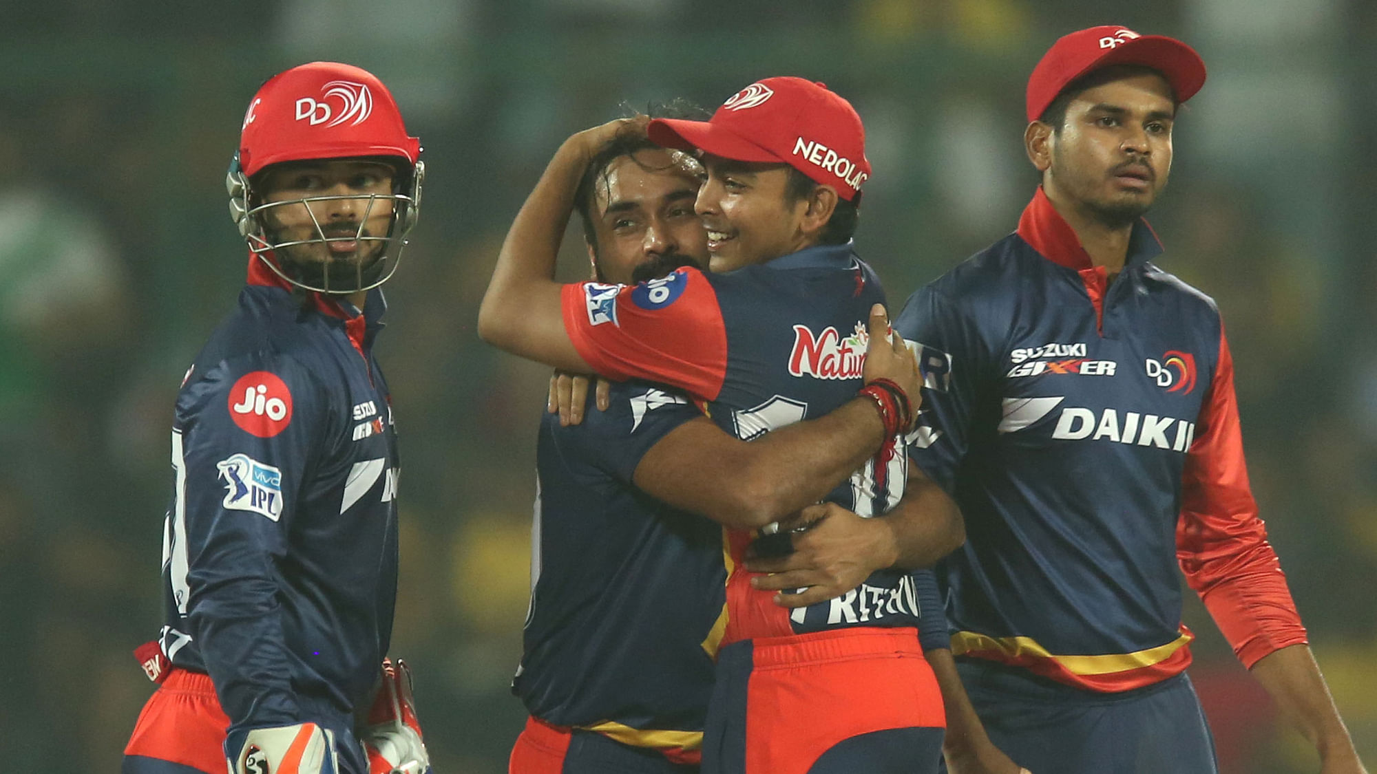 Amit Mishra celebrates a wicket with his teammates.