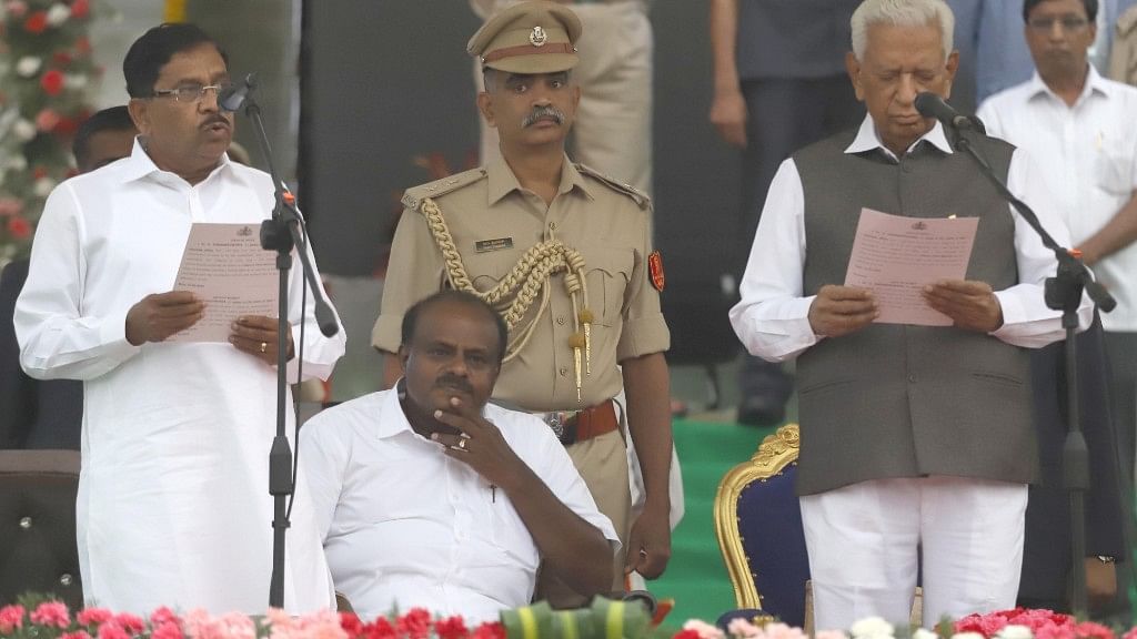  Karnataka Governor Vajubhai Vala administers the oath of office to Congress leader G Parameshwara, during a swearing-in ceremony at Vidhana Soudha in Bengaluru on 23 May. 