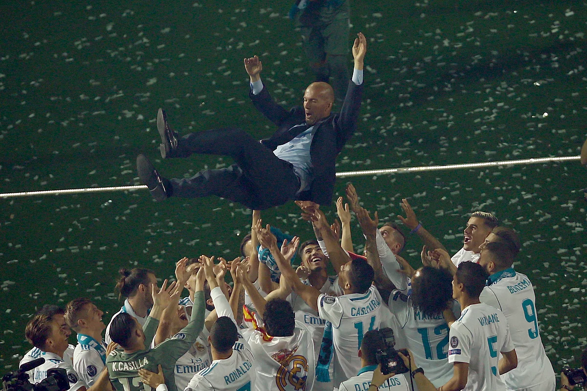 Real Madrid players lift head coach Zinedine Zidane into the air as they celebrate after winning the Champions League final at the Santiago Bernabeu stadium in Madrid.