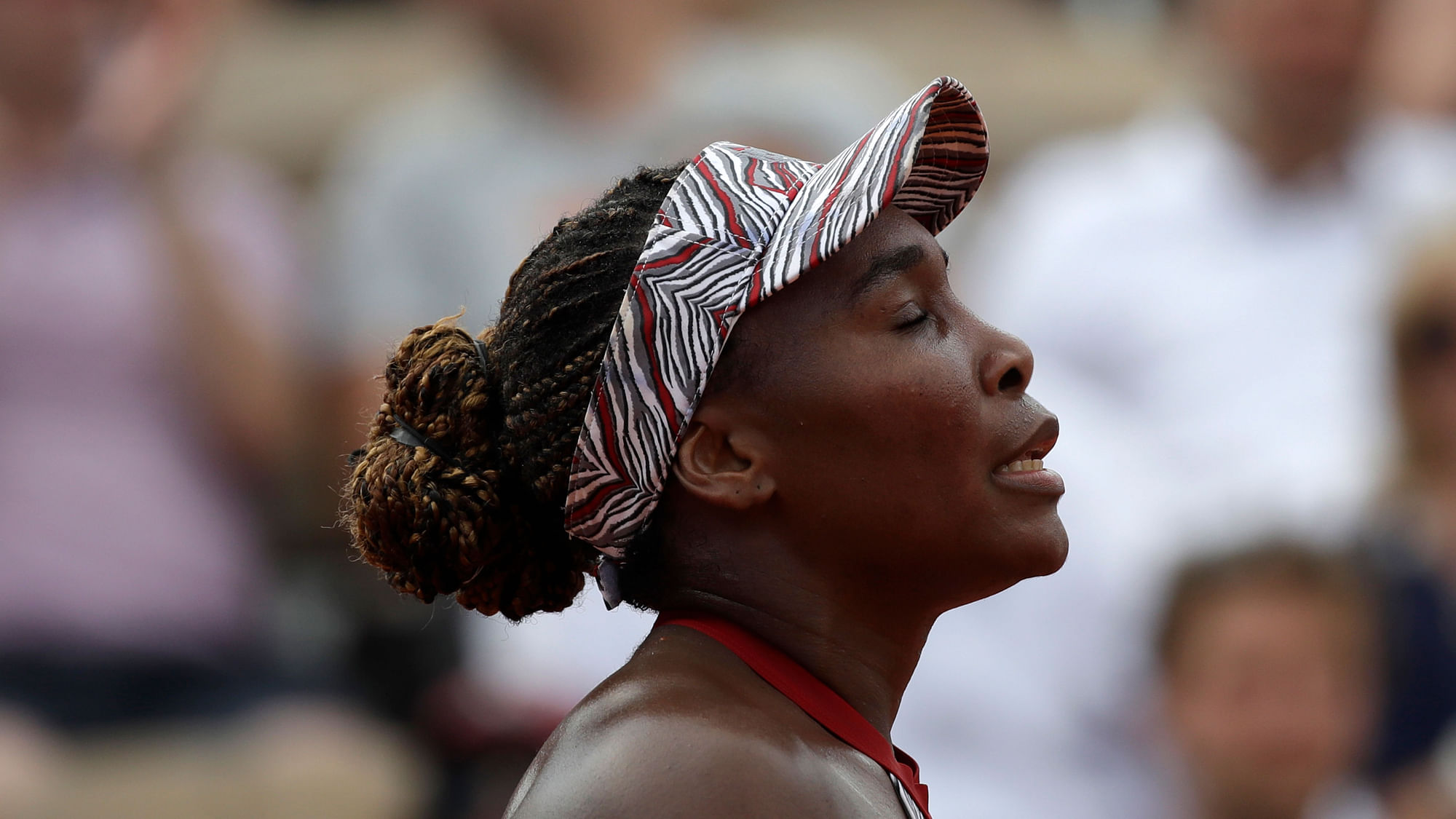Venus Williams closes her eyes after losing to China’s Qiang Wang during their first round match of the French Open tennis tournament at the Roland Garros Stadium.