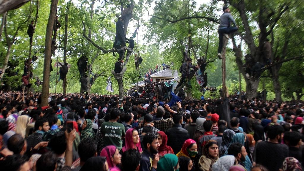 People attend the funeral of slain militant Saddam Padder.&nbsp;