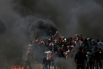 GAZA, May 14, 2018 (Xinhua) -- Palestinian protesters clash with Israeli troops near the Gaza-Israel border, east of Gaza City, on May 14, 2018. More than 40 Palestinians, including children, were killed Monday in a day of violent clashes with Israeli forces on Israel