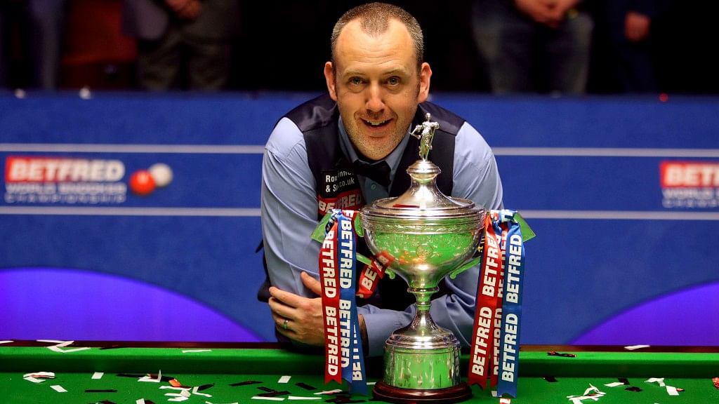 Britain’s Mark Williams poses with the trophy after winning the 2018 Snooker World Championship at The Crucible in Sheffield in England on Monday,