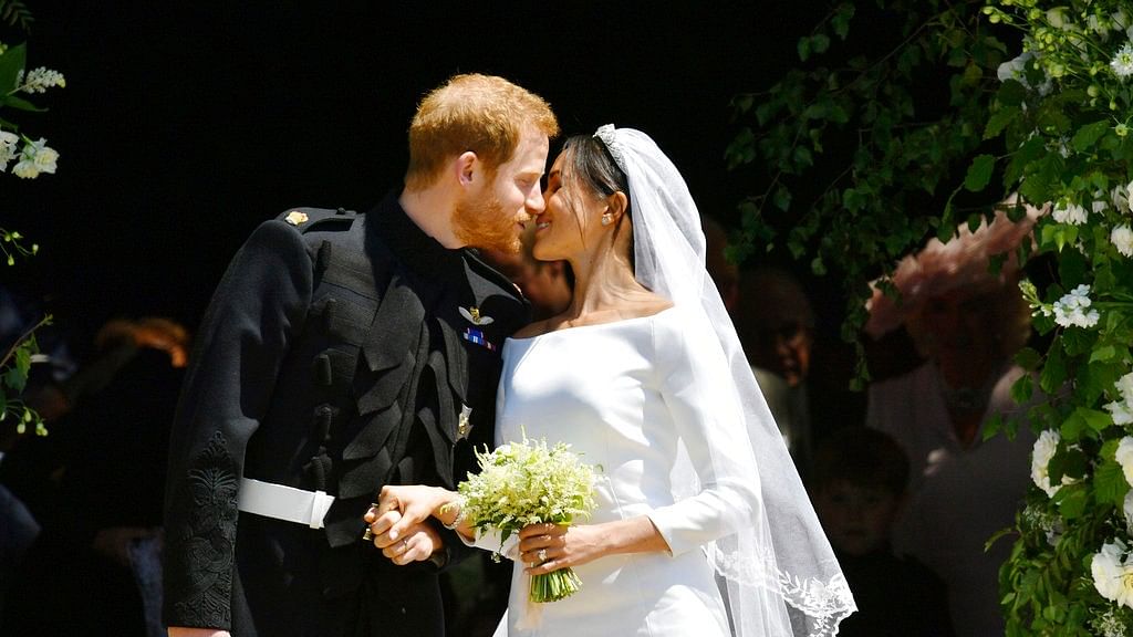 Prince Harry and Meghan Markle kiss on the steps of St George’s Chapel in Windsor Castle after their wedding in Windsor, near London, England, Saturday, May 19, 2018.