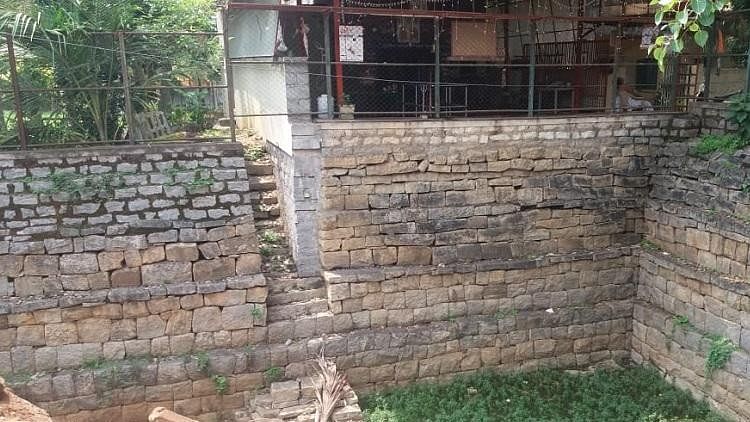 The temple tank in Gottigere has been filled with construction debris by the contractor involved in the road-widening project.