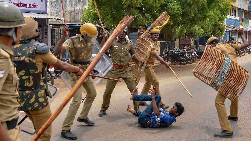 Tuticorin: Police personnel baton charge at a protester demanding the closure of Sterlite Copper unit, in Tuticorin, on Wednesday, 23 May.&nbsp;