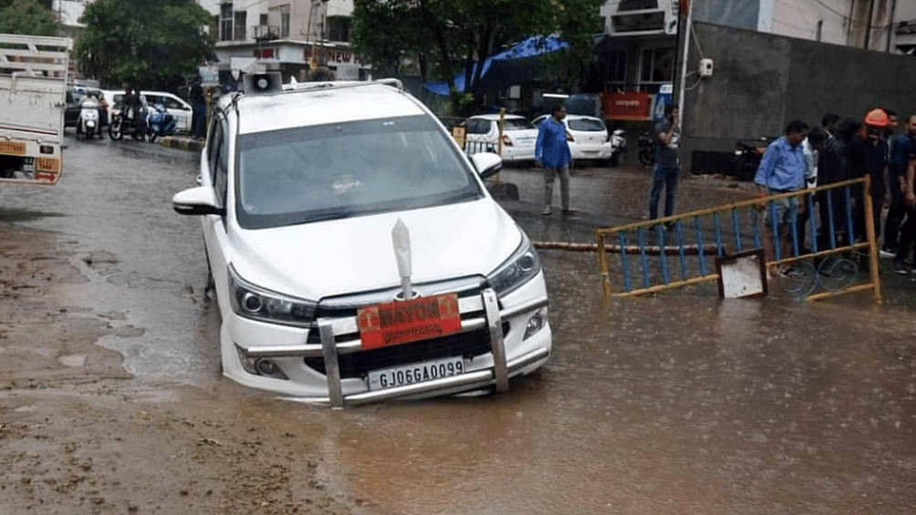 The vehicle, belonging to Vadodara Mayor Dr Jigisha Seth, got stuck after a road caved in following heavy rains in the city on 25 June.