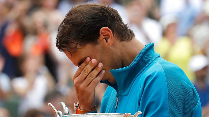 Rafael Nadal is overcome with emotion as he celebrates his 11th French Open title.