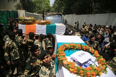 Jammu: Soldiers carry the coffins of the two Border Security Force (BSF) troopers who were killed in Pakistan shelling and firing on the International Border in Jammu district of Jammu and Kashmir on June 3, 2018. (Photo: IANS)